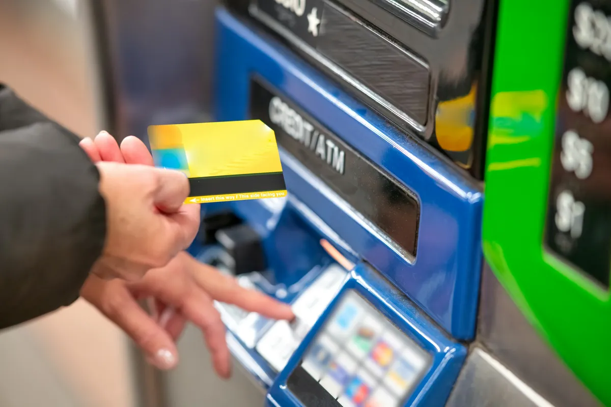 man withdrawing cash atm fees and charges abroad