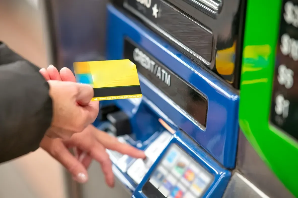 man withdrawing cash atm fees and charges abroad